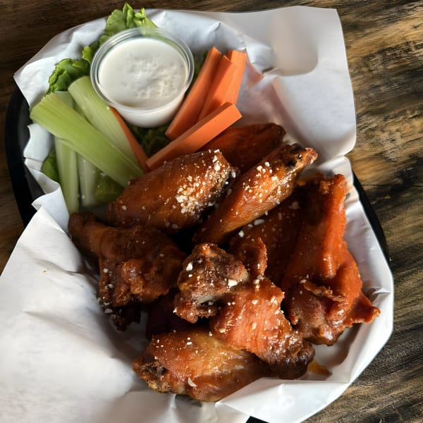 Steele 94 Restaurant Bar's chicken wings with celery, carrots, and ranch dressing.